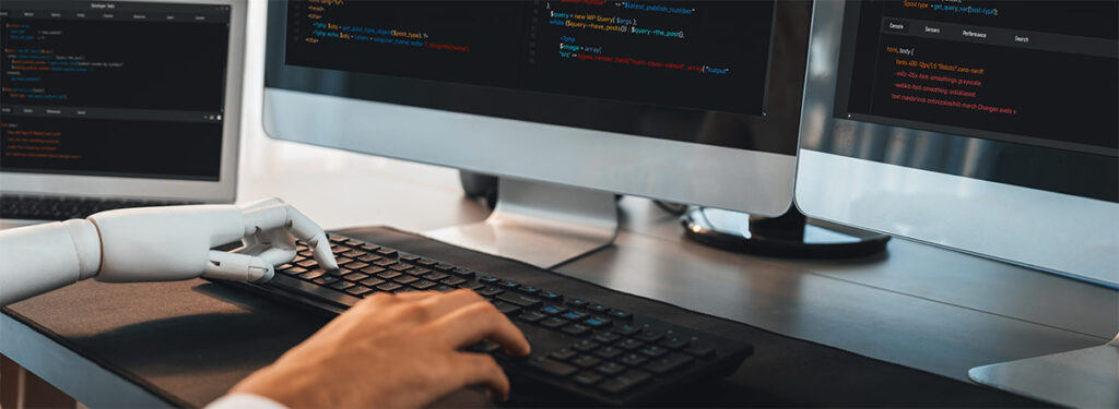 Human and AI writing depicted by a person's hand and a robotic hand typing on a keyboard.