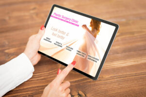 Cosmetic surgeon holding a tablet and browsing a plastic surgery website with a good User Experience.